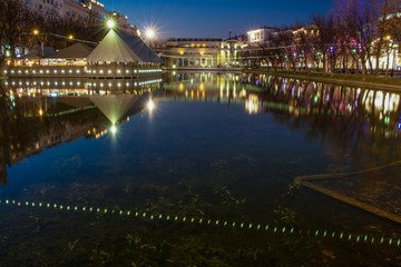 Fototapeta na wymiar Clean city pond at night. Beautiful multicolored illumination