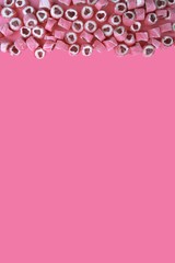 Pink candy hearts on a pink background. Romantic background with copy space