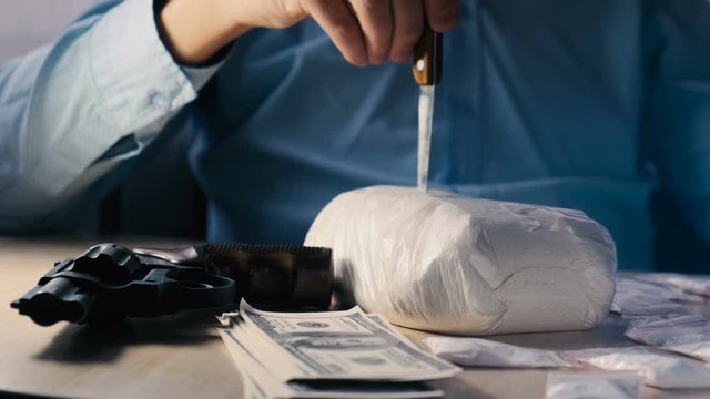 Drug dealer punching knife with heroin pack. The concept of drug trafficking and the black drug market