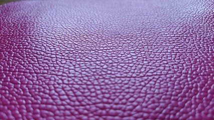 Artificial leather is bright pink or fuchsia. Distinct furrows and elevations on the surface of a...