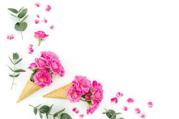 Floral composition with pink roses and eucalyptus on white background. Flat lay, top view.