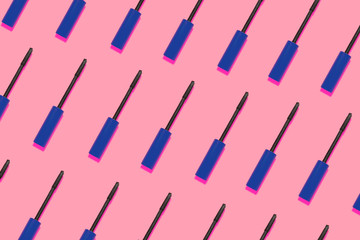 Mascara brush pattern on a pink background