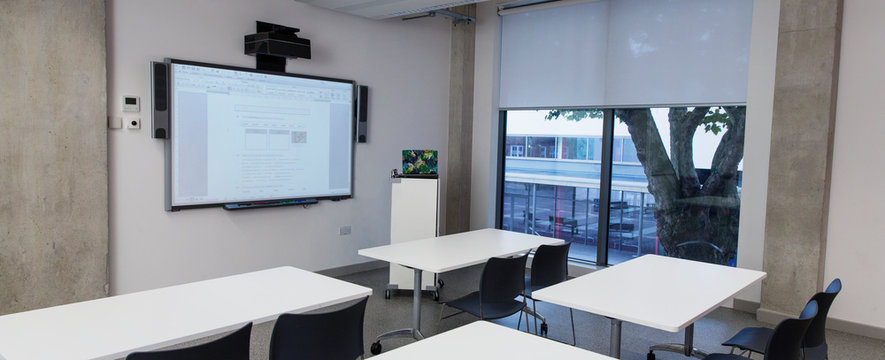 Empty classroom with projection screen