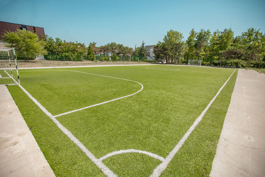 Corner position on a mini football field. Football field without people with green grass from different angles