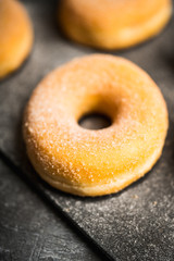 Donut with apple jam on the rustic background. Selective focus.