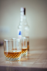glass of whiskey and ice on black background