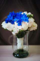bouquet of flowers in a vase on wooden table