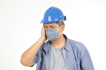 An Asian engineer wears a blue helmet, wears a dust mask and Coronavirus. He has a headache and is sick. The concept of prevention of the common cold and infection. White background