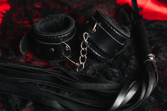 Leather handcuffs and whip for BDSM role-playing sex games
