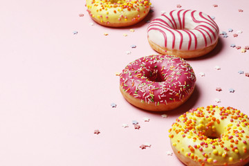 Sweet donuts on a pink background. Place for text