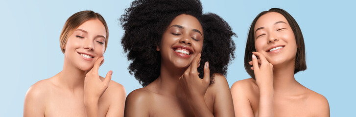 Optimistic multiethnic women applying cream on face