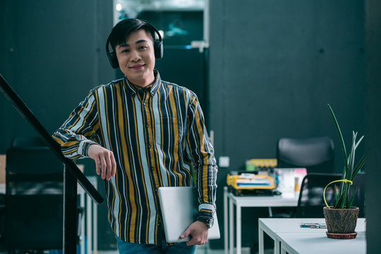 Pleased Young Worker In The Office Stock Photo