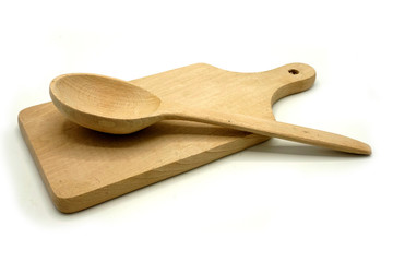 Wooden kitchen utensils on white background. Handcrafted cutting board and spoon.