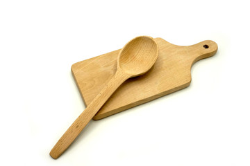 Wooden kitchen utensils on white background. Handcrafted cutting board and spoon.