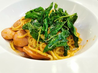 the Asian Thai Italian spaghetti with spicy sausage sauce in the plae tin the restaurant