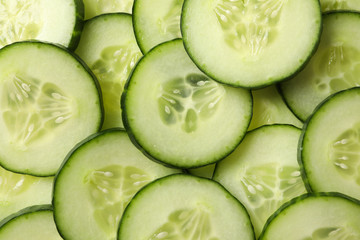 Green cucumber slices texture background, close up