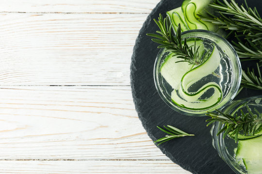 Glasses With Cucumber Water On Tray On Wooden Table, Top View