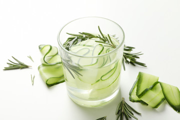 Glass with infused cucumber water on white background, close up