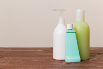 Cleaning product plastic container for house clean on wooden table and gray background . household chemicals