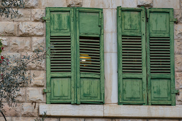 Fototapeta na wymiar Green old wooden shutters. Jerusalim The wooden shutters are green.