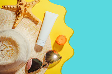 Sunscreen. Straw hat with sun glasses, protection cream SPF Beach accessories. Summer Travel Concept