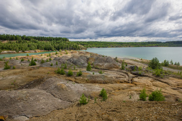 Flooded clay quarry lake with green water landscape