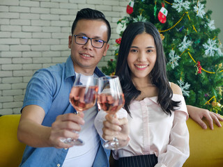 the asian young man and woman drinking red wine together having romantic time together at home for valentine festival