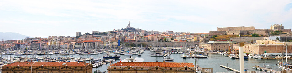 Marseille, France.  Panoramic View of Old Port Harbor and Marina, Notre Dame Cathedral on the Hill in the Distance