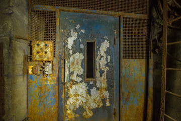 Old rusty lift in abandoned gold mine underground tunnel