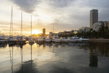 Port with boats and buildings in Alicante.