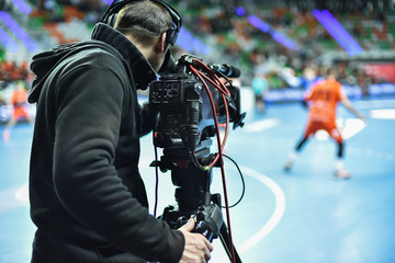 TV camera and cameraman during handball match