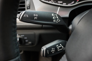 Closeup lane departure warning system LDWS and adaptive cruise control leavers close-up. Concept of reducing road hazard and improving driving safety.