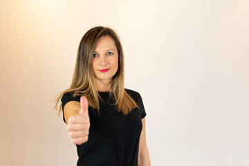 Young woman with finger gesture up smiling