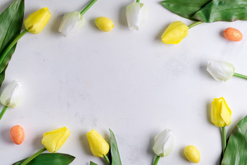 Flat Lay of Easter Eggs with tulips on stone marble background. Easter background or easter concept.