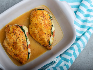 Baked chicken fillet stuffed with spinach, tomatoes and cheese