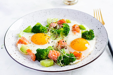 Ketogenic/paleo diet. Fried eggs, salmon, broccoli and microgreen.  Keto breakfast. Brunch.