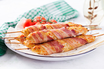 Minced Lula kebab grilled turkey (chicken) with pumpkin wrapped in bacon on plate.