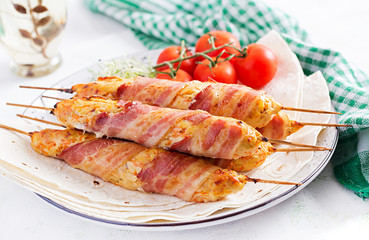Minced Lula kebab grilled turkey (chicken) with pumpkin wrapped in bacon on plate.