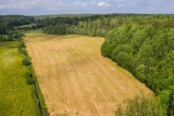 Fototapeta na wymiar Aerial view of a yellow field with hay bales