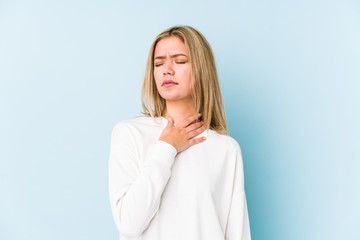 Young blonde caucasian woman isolated suffers pain in throat due a virus or infection.