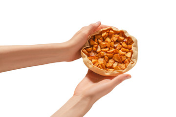 Obraz premium This apple pie is in female hands on a white background.
