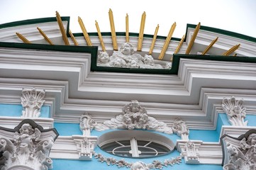 Figures on an old building. City architecture.