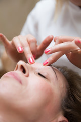 Obraz na płótnie Canvas Closeup face of a woman having facial massage at spa