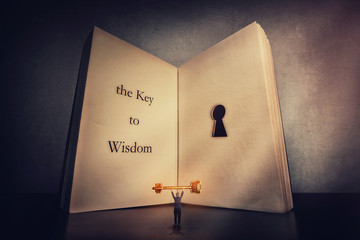 Person found the magic golden key to wisdom, stands near the giant book with a keyhole inside...