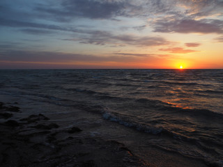 Fototapeta na wymiar Sunrise over the sea beach