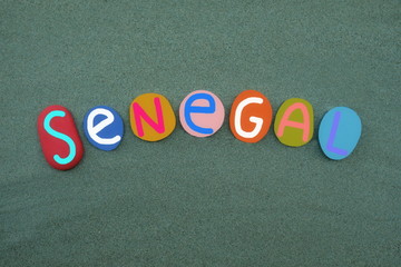Senegal, country in West Africa, souvenir with multi colored stone letters over green sand
