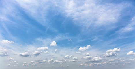 Blue clear sky with scattered clouds during the day