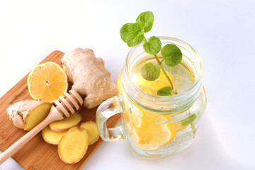 Glass of water, lemon, mint and ginger as background. Detox.