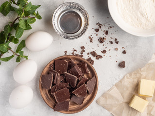 Chocolate, eggs, butter, flour on the table. Top view.