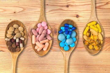 Supplement vitamin and health herbal pills in spoons